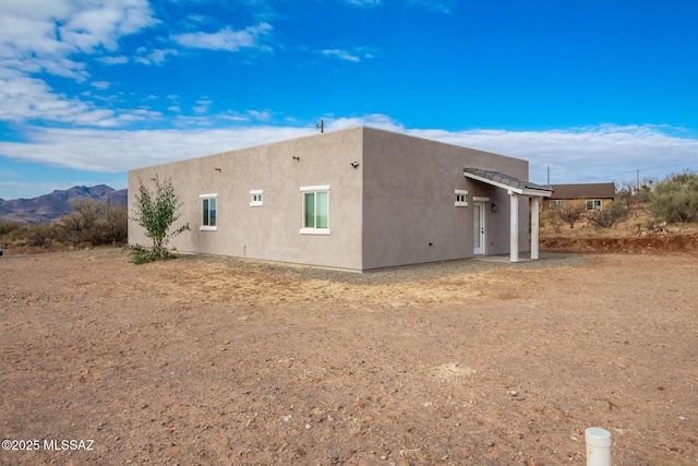 view of side of home featuring a mountain view