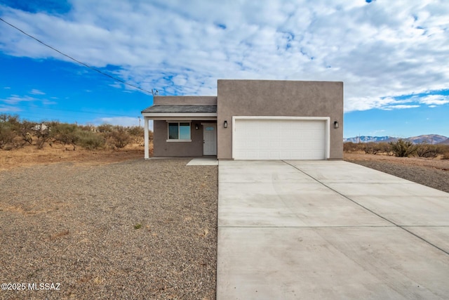 view of front facade featuring a mountain view and a garage