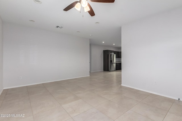 spare room featuring light tile patterned flooring and ceiling fan