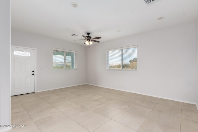 empty room with plenty of natural light and ceiling fan