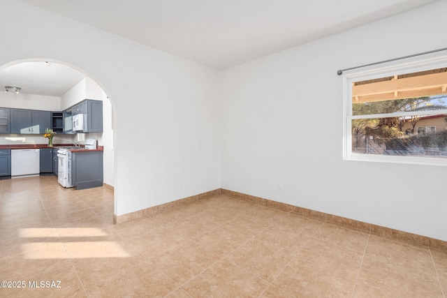 unfurnished room featuring light tile patterned flooring