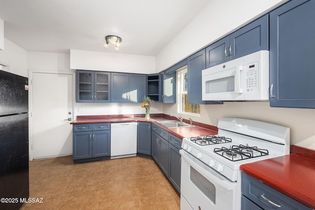 kitchen with blue cabinetry, white appliances, and sink