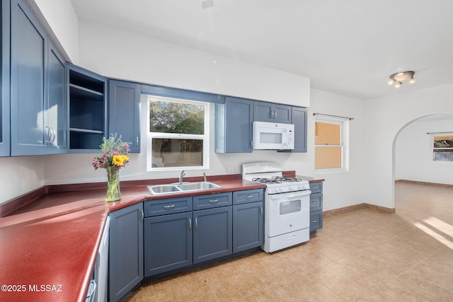 kitchen featuring blue cabinetry, white appliances, and sink