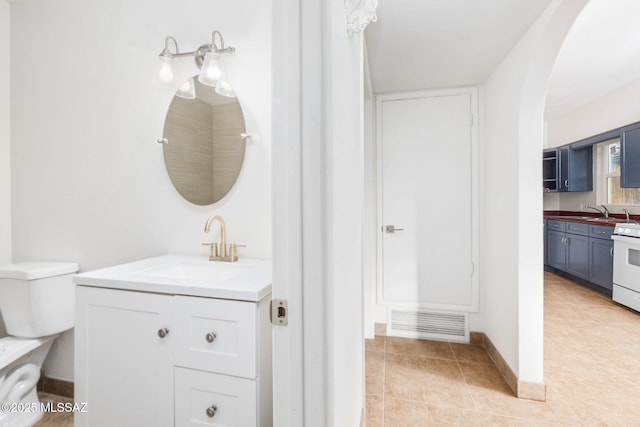 bathroom featuring tile patterned floors, toilet, and vanity