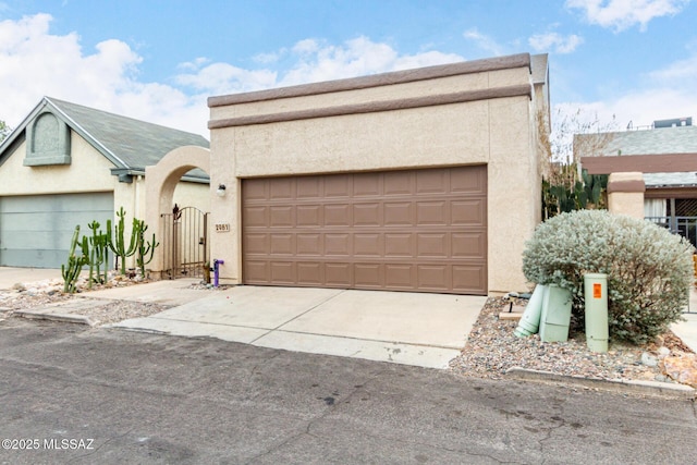 pueblo revival-style home with a garage