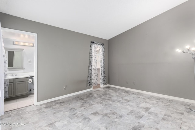 unfurnished room with vaulted ceiling