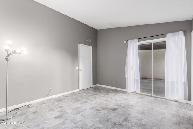 unfurnished room with lofted ceiling