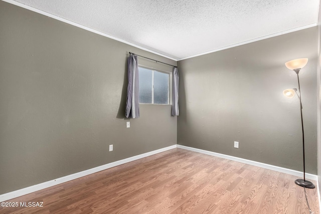 unfurnished room with crown molding, light hardwood / wood-style flooring, and a textured ceiling