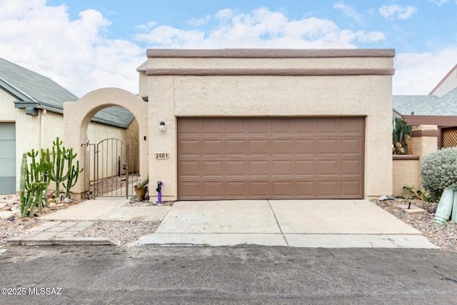 pueblo-style home with a garage