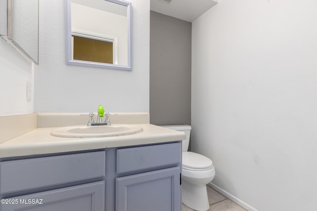 bathroom with vanity, tile patterned floors, and toilet