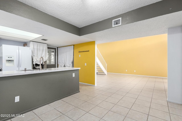 interior space with sink and a textured ceiling