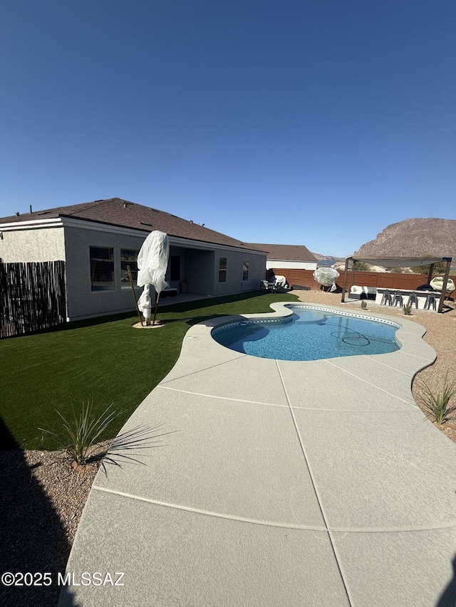 view of swimming pool with a yard and a patio