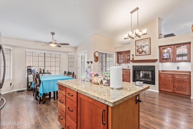 kitchen featuring a wealth of natural light, a kitchen island, dark hardwood / wood-style floors, and pendant lighting