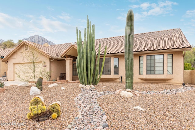 view of front of house featuring a mountain view and a garage