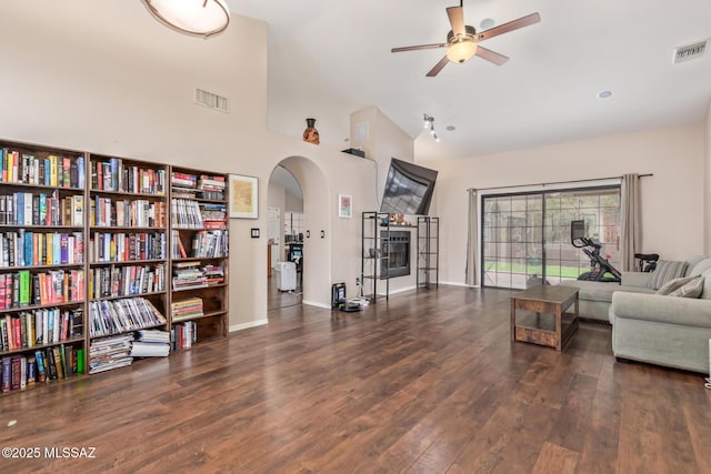 interior space with ceiling fan, high vaulted ceiling, and dark hardwood / wood-style flooring