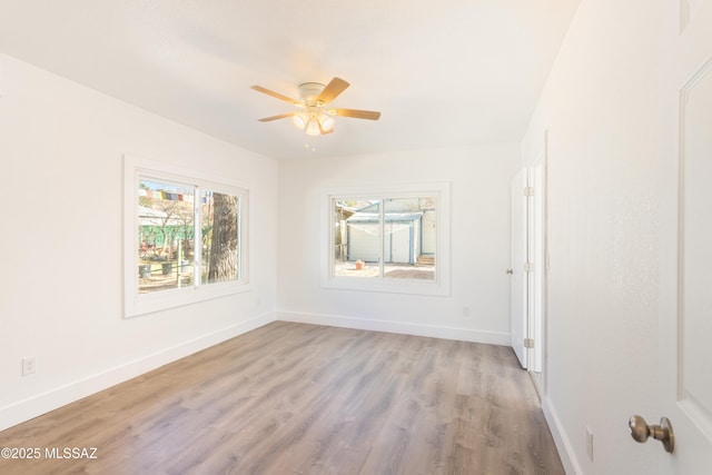 spare room featuring ceiling fan and light wood-type flooring