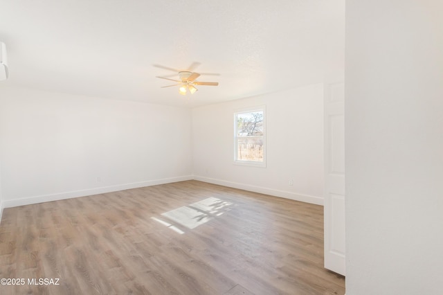 unfurnished room featuring ceiling fan and light hardwood / wood-style flooring