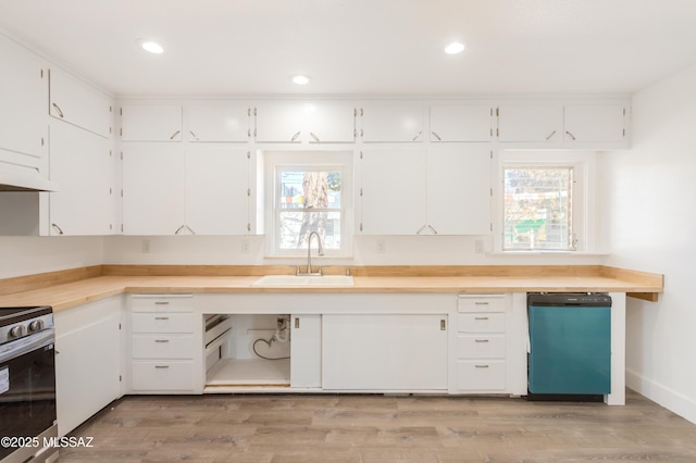 kitchen with dishwashing machine, sink, stainless steel range with electric cooktop, and white cabinets