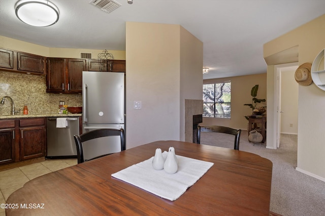 carpeted dining space featuring sink