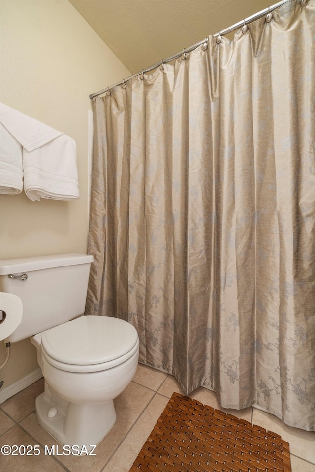 bathroom featuring tile patterned flooring and toilet