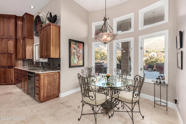 dining room featuring sink and a high ceiling