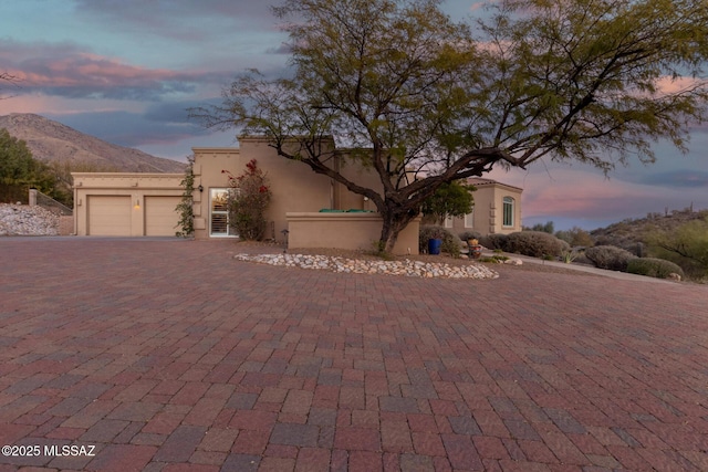 view of front facade featuring a mountain view and a garage