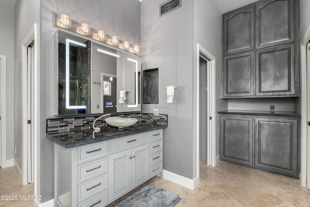 bathroom featuring tasteful backsplash and vanity