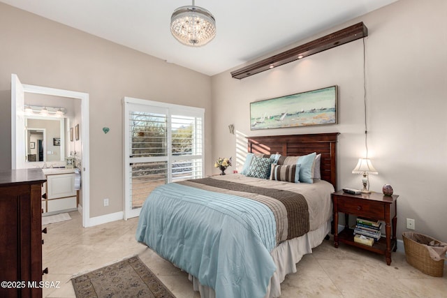 tiled bedroom with a notable chandelier and ensuite bathroom