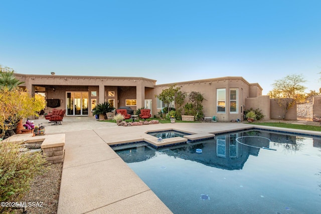 view of pool featuring an in ground hot tub and a patio