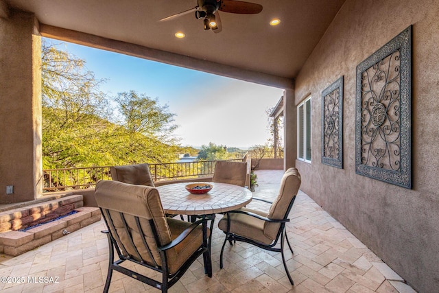 view of patio with ceiling fan and an outdoor fire pit