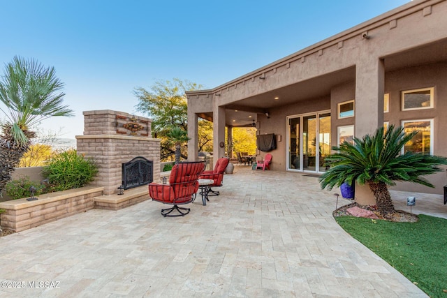 view of patio / terrace featuring an outdoor brick fireplace