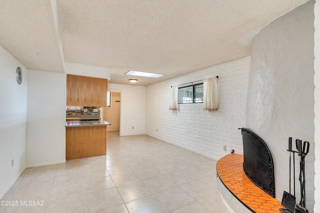 tiled living room with brick wall and a textured ceiling