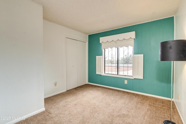 spare room with carpet and a textured ceiling