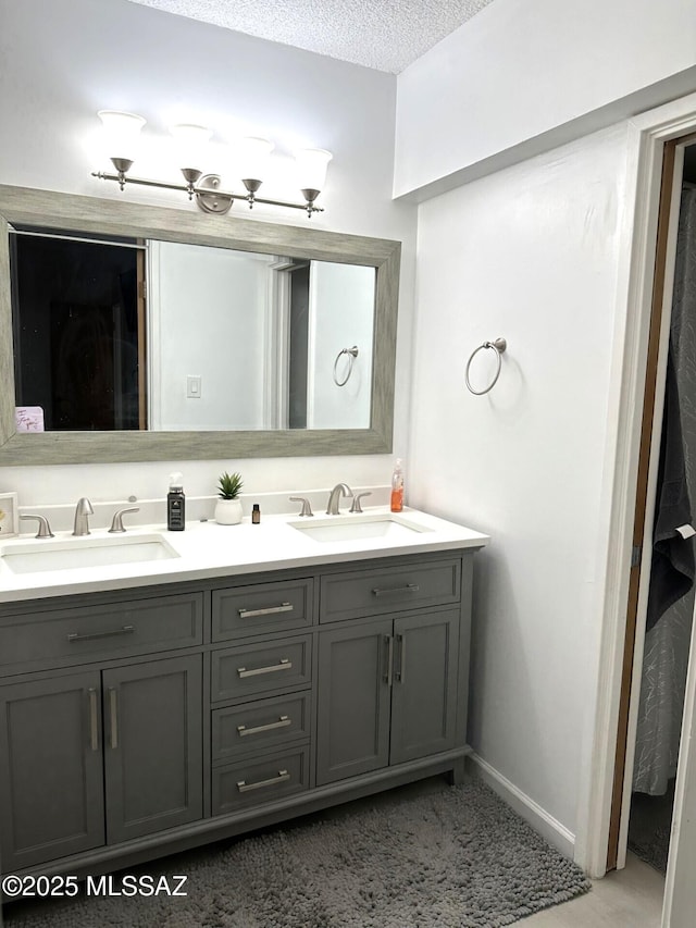 bathroom featuring vanity and a textured ceiling