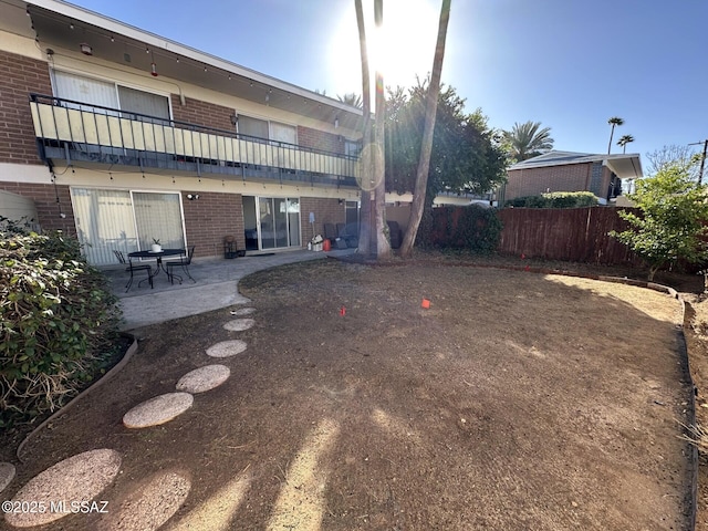 view of yard with a balcony and a patio area