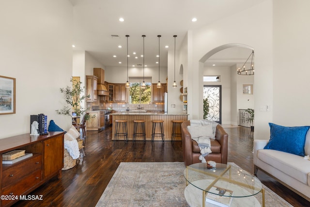 living room featuring a notable chandelier and dark hardwood / wood-style flooring