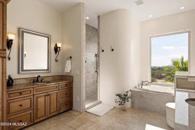 bathroom with vanity, tile patterned floors, and shower with separate bathtub