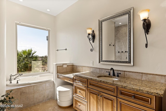 bathroom featuring a relaxing tiled tub, tile patterned floors, and vanity