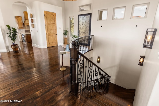 staircase with hardwood / wood-style flooring