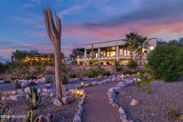 yard at dusk with a balcony