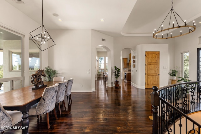 dining space with dark wood-type flooring and a chandelier