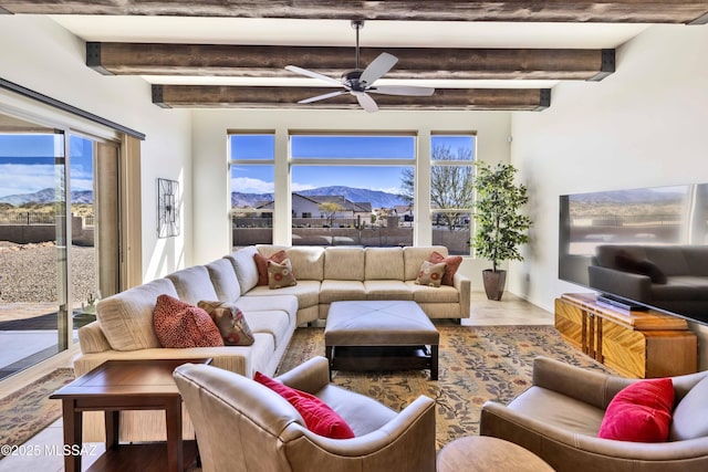 living room featuring ceiling fan, wood-type flooring, and beamed ceiling