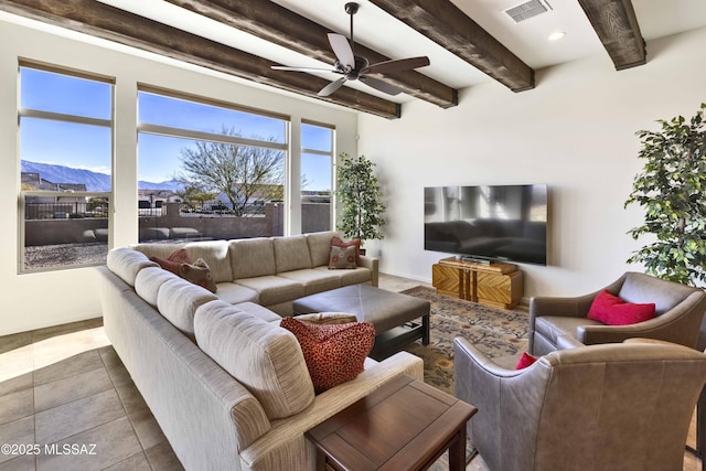 tiled living room with beamed ceiling, a mountain view, and ceiling fan