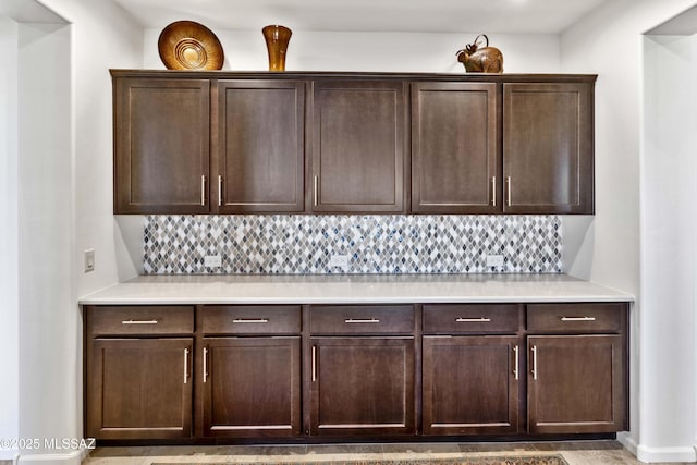 interior space with dark brown cabinetry and backsplash