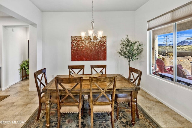 dining area with an inviting chandelier