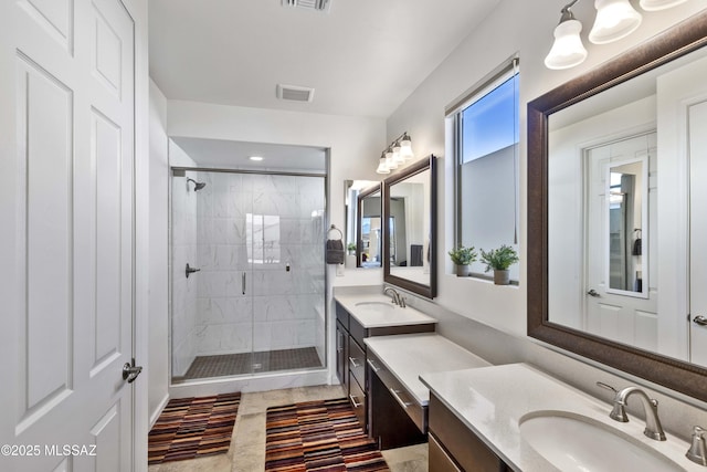 bathroom featuring vanity and a shower with door