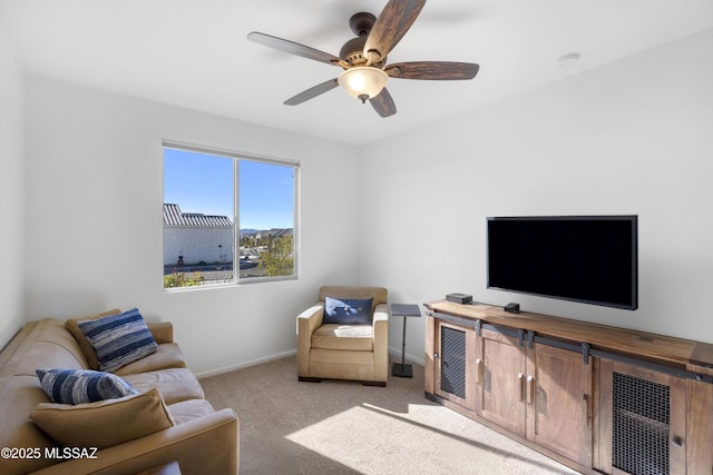 living room with ceiling fan and light colored carpet