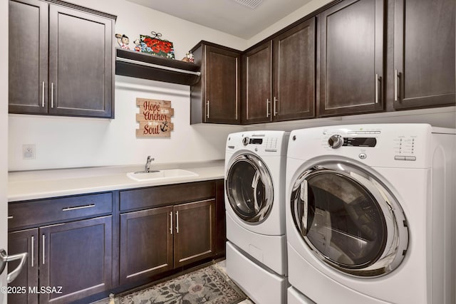 laundry room with sink, cabinets, and washing machine and clothes dryer