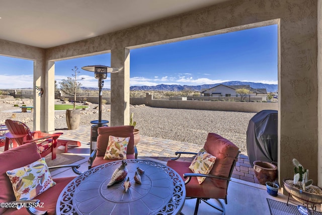 view of patio / terrace with a mountain view and area for grilling