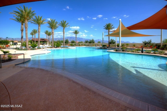 view of swimming pool with a patio and a mountain view